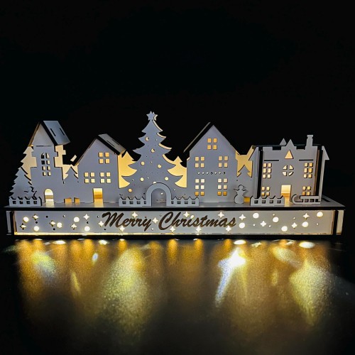 White Wood Christmas Light up Decoration Featuring a Village Scene With Tree and Houses. Laser Cut Wood is Hand Assembled With LED Lights. UK