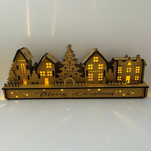 Wooden Christmas Light up Decoration Featuring a Village Scene With Tree and Houses. Laser Cut Wood is Hand Assembled With LED Lights. UK